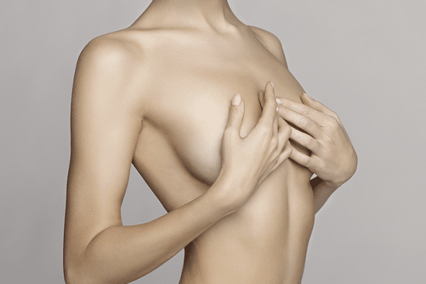 Women hiding her breast after breast reduction