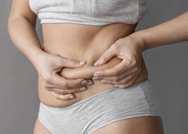 Woman grabbing her abdomen