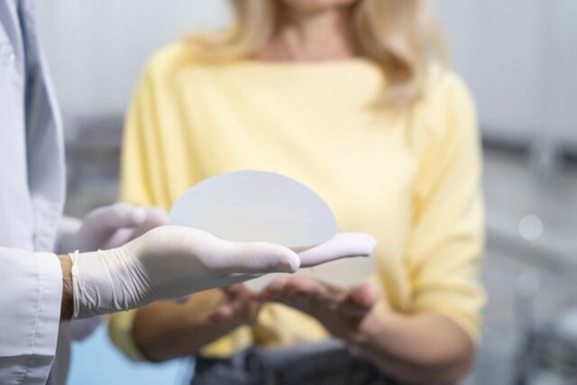 Plastic Surgeon Showing a Breast Implant