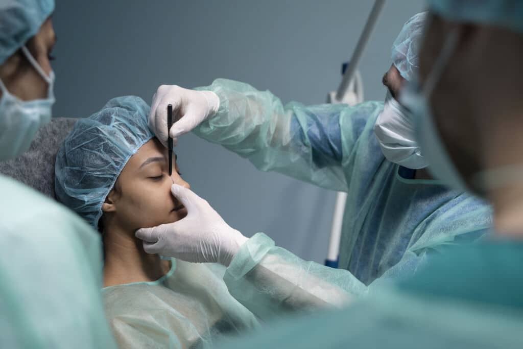 side view doctor checking-patient before rhinoplasty