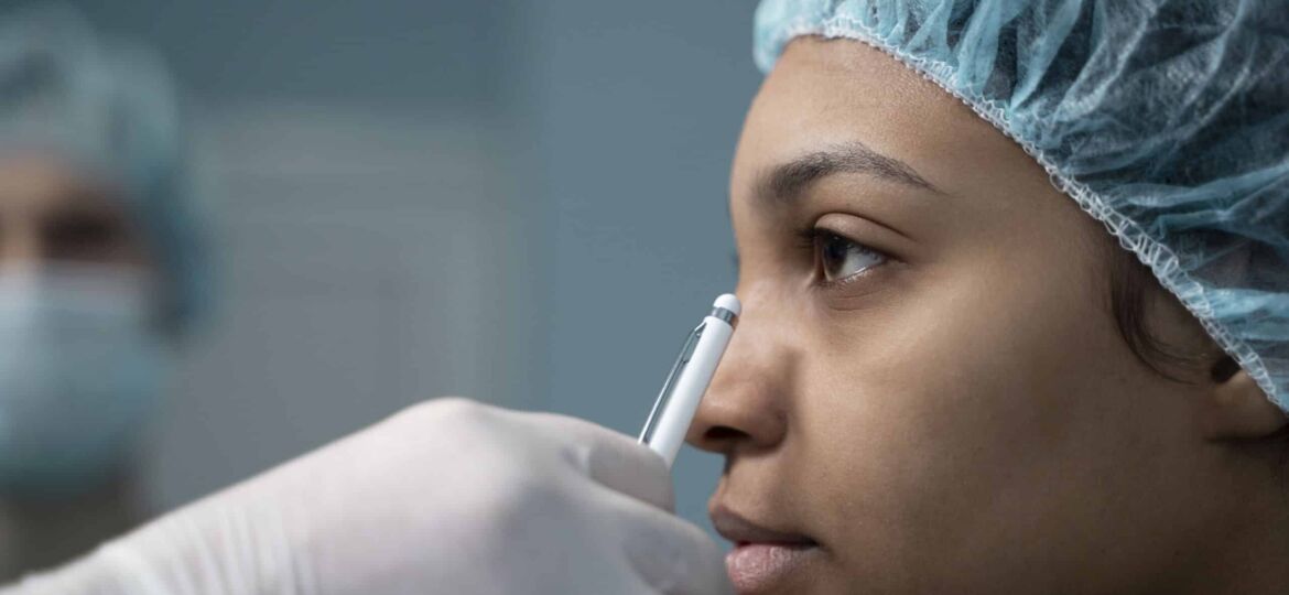 side view doctor checking nose job patient