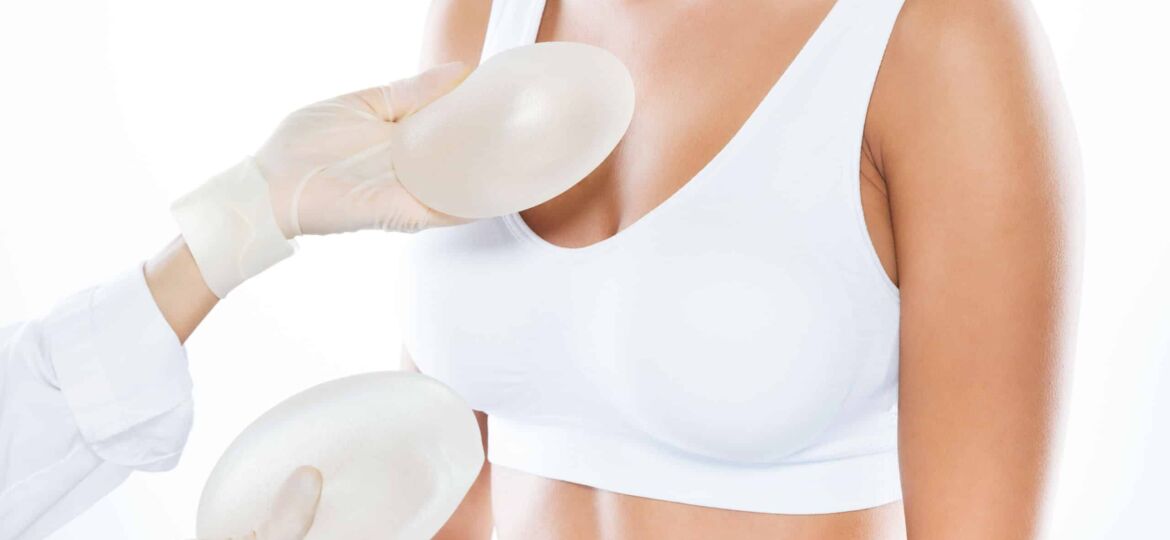 Female doctor choosing mammary prosthesis with her patient over