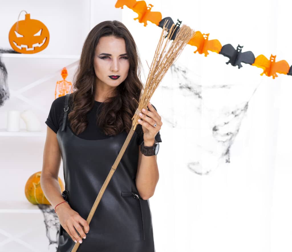 beautiful adult woman with halloween broom