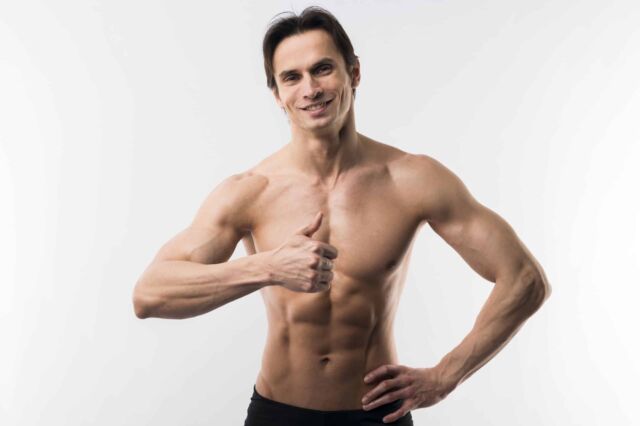 front-view-muscled-man-posing-while-giving-thumbs-up