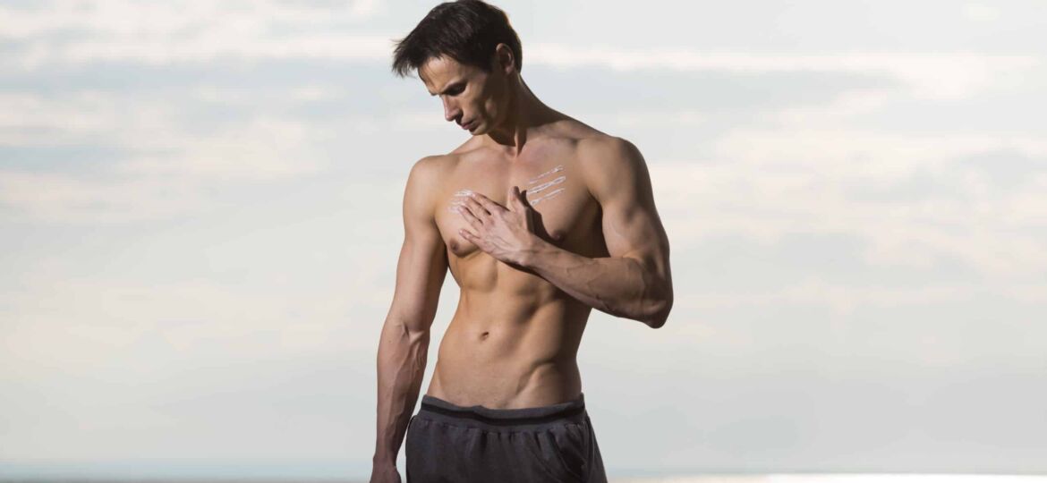 Man in the beach after a gynecomastia surgery