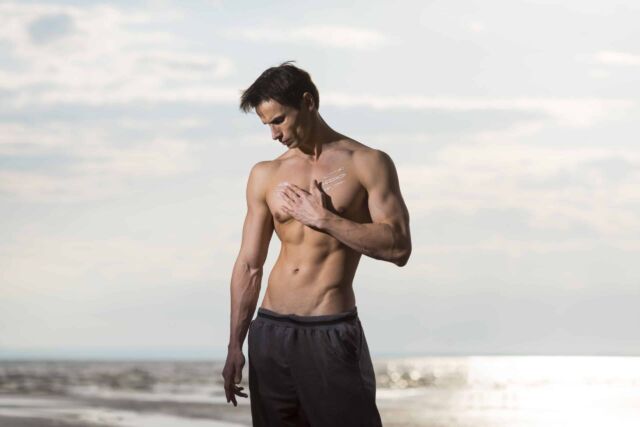 Man in the beach after a gynecomastia surgery